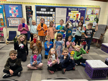 students displaying gift from community