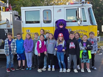 students in front of fire truck with Panther mascot