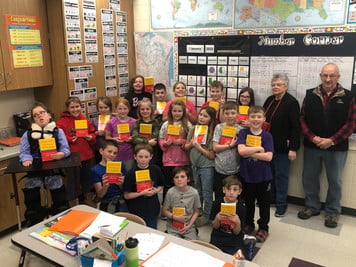 students showing donated book