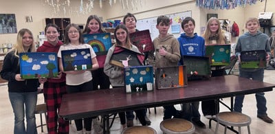 students showing art project
