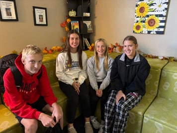 students sitting on a couch